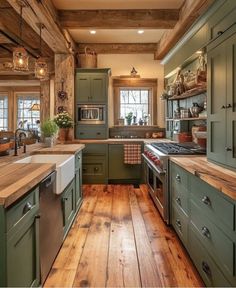 a kitchen with green cabinets and wood floors in the center, along with wooden flooring