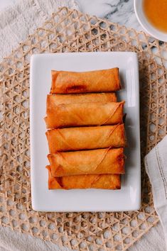 some food is on a white plate and next to a cup of tea or coffee