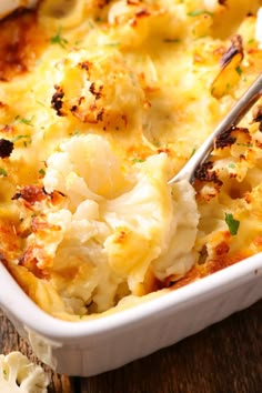 a white casserole dish filled with cauliflower and cheese