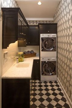 a washer and dryer in a small room with checkered flooring on the walls