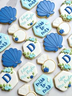 decorated cookies with blue and white icing on a table