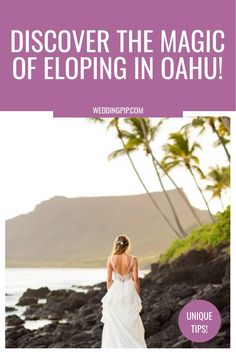 Bride in a white dress stands on rocky shore, palm trees and mountains in the background. Mountain Backdrop, Tropical Beauty, Intimate Elopement