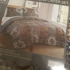 an advertisement for a comforter set on display