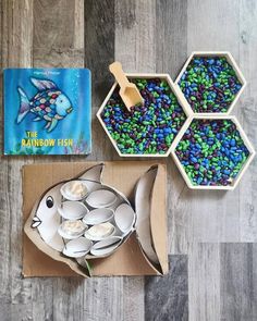 there are three bowls and two plates with food in them next to a children's book