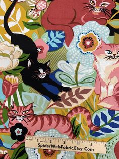 an image of cats and flowers on a colorful background with a ruler in the foreground