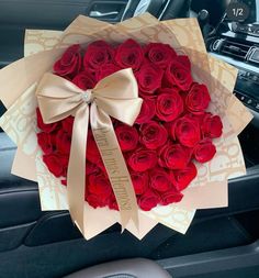 a bouquet of red roses in a car