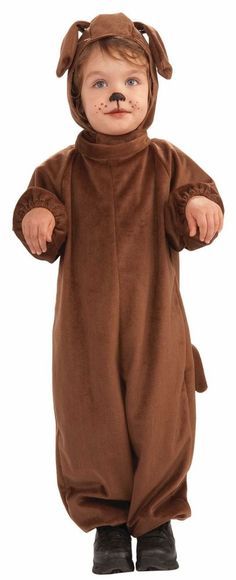 a child in a brown bear costume standing with his hands on his hips and eyes closed