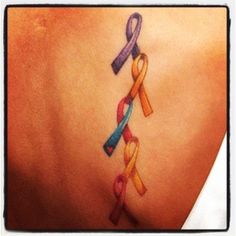 a woman's back with multiple colored ribbons on it