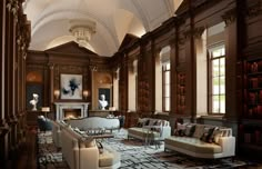 a large living room filled with furniture and bookshelves