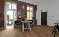 a room with wooden floors and brick walls