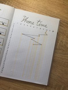 an open notebook with lines and numbers on the page that says phone time, next to a calculator