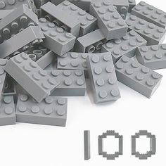 a pile of grey lego blocks sitting on top of each other next to the word q