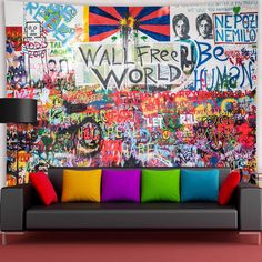 a living room filled with lots of colorful furniture and graffiti on the wall behind it