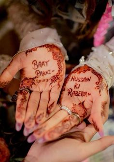 two people holding their hands painted with hendi designs and writing on them that read bratt dance