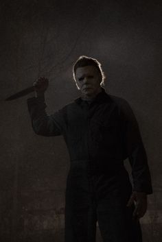 a man holding a knife in the dark