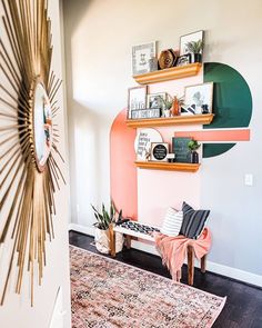 a living room filled with furniture and decor on top of a wooden floor next to a wall