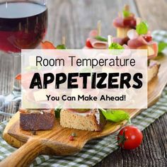 some appetizers are on a wooden board with wine in the background and text overlay that reads room temperature appetizers you can make ahead