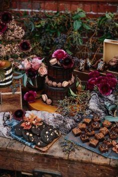 a table topped with lots of desserts and flowers