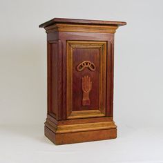 an ornate wooden clock on display against a white background