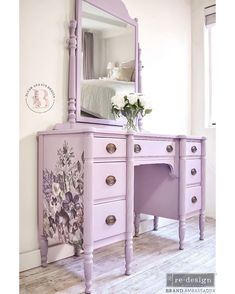 a purple dresser with flowers painted on the side and a mirror above it that is next to a bed