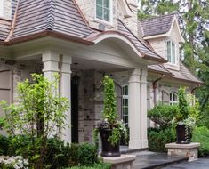 a house with two large planters in front of it