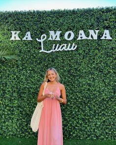 a woman standing in front of a green wall