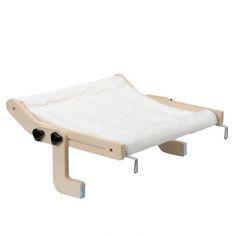 a wooden bed frame with a white blanket on the top and two black wheels attached to it