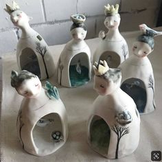 seven ceramic figurines are sitting on a table