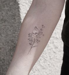 a woman's arm with a flower tattoo on the left side of her body