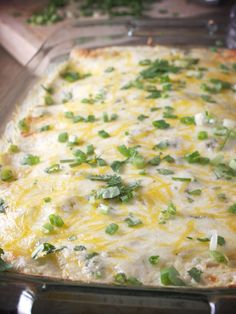 a casserole dish with green onions and cheese