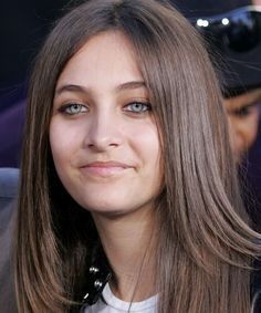 a close up of a person with long hair