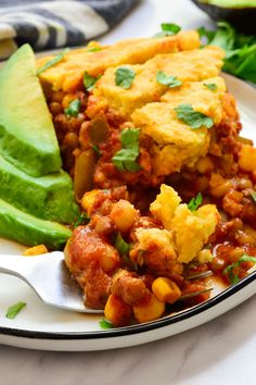 a close up of a plate of food with avocado