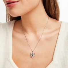 This pretty necklace for her features a double heart-shaped pendant traced in shimmering diamond accents. At the center sits a beautiful heart-cut lab-created emerald to complete the romantic design. The sterling silver pendant is suspended from an 18-inch box chain and secures with a lobster clasp. Heart-shaped Emerald Necklaces For Anniversary, Heart-shaped Emerald Necklace For Anniversary, Anniversary Heart-shaped Emerald Necklace, Elegant Heart Necklace For May Birthstone, Heart-shaped Emerald Jewelry For Valentine's Day, Elegant Green Heart Necklace For Valentine's Day, Valentine's Day Heart Shaped Emerald Jewelry, Elegant Heart Cut May Birthstone Necklaces, Elegant Heart Cut Necklaces For May Birthstone