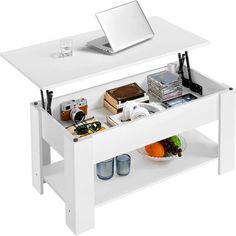 a white coffee table with an open drawer underneath it and a laptop on the top