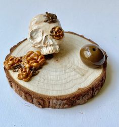 a piece of wood with a skull on it and some nuts in front of it