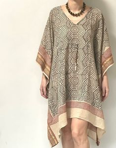 Elevate your summer wardrobe with our Black Geometric Print Short Kaftan, designed for style and comfort. Crafted from 100% cotton, this kaftan offers a loose and comfy fit, perfect for various occasions from beach vacations to poolside lounging. Details: Size: One size fits most Length: Short, knee-length Material: 100% Cotton Care: Hand wash separately in cold water, light iron Features a drawstring in the middle for a better fit Versatile Style: Ideal for cruises, beach vacations, bridesmaid gifts, poolside wear, and lounging With its chic geometric print and relaxed silhouette, this kaftan is a must-have addition to your summer wardrobe. Enjoy effortless style and comfort wherever you go with our Black Geometric Print Short Kaftan. Short Kaftan Dress, Short Kaftan, Cotton Caftan, Black Indians, Indian Block Print, Beach Vacations, Kimono Dress, Kaftan Dress, Long Sleeve Midi Dress