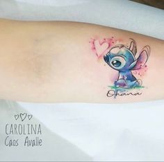 a small tattoo on the arm of a girl with an eyeball and heart in it