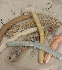 five different colored umbrellas laying on top of a white table cloth covered tablecloth