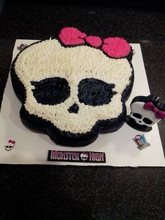 a decorated cake with a skull and bow on it