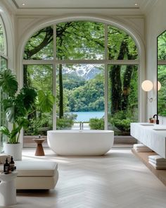 an elegant bathroom with large windows overlooking the lake