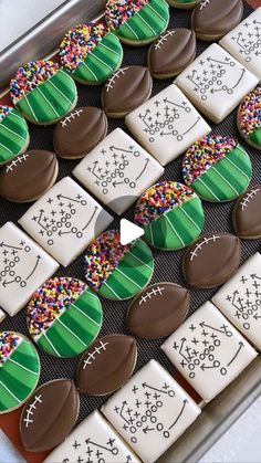 decorated cookies in the shape of footballs on a tray