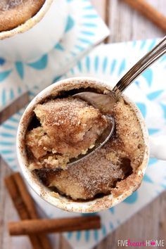 two mugs filled with hot chocolate and cinnamon