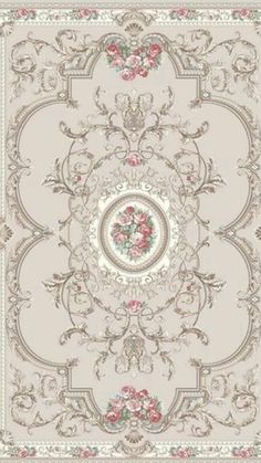 a beige and pink rug with roses on the center, surrounded by ornate scrolls and floral designs