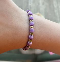 Clay bead bracelet with 2 shades of purple and gold beads in a repeating pattern. This bracelet is 2 inches in diameter and would be suitable for a child or young adult/adult with a smaller wrist. There is a little stretch, but not much. Adjustable Purple Bracelets With Tiny Beads, Adjustable Purple Bracelet With Tiny Beads, Trendy Purple Jewelry With Spacer Beads, Purple Stretch Bracelet With Tiny Beads As Gift, Trendy Purple Jewelry With Tiny Beads, Trendy Purple Friendship Bracelets With Colorful Beads, Purple Stretch Bracelet With Letter Beads, Purple Friendship Bracelets With Spacer Beads, Adjustable Purple Beaded Bracelets With Letter Beads