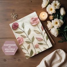 a table topped with flowers next to a candle