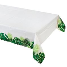 a white table cloth with green palm leaves on it and a black border around the edge