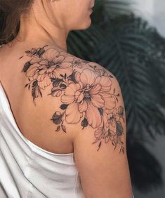 a woman with a flower tattoo on her shoulder