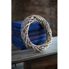 a stack of folded blue cloths sitting on top of a wooden table