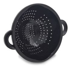 a black colander with holes on the side and handles, sitting in front of a white background