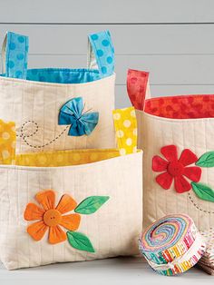 three bags with flower designs on them sitting next to each other